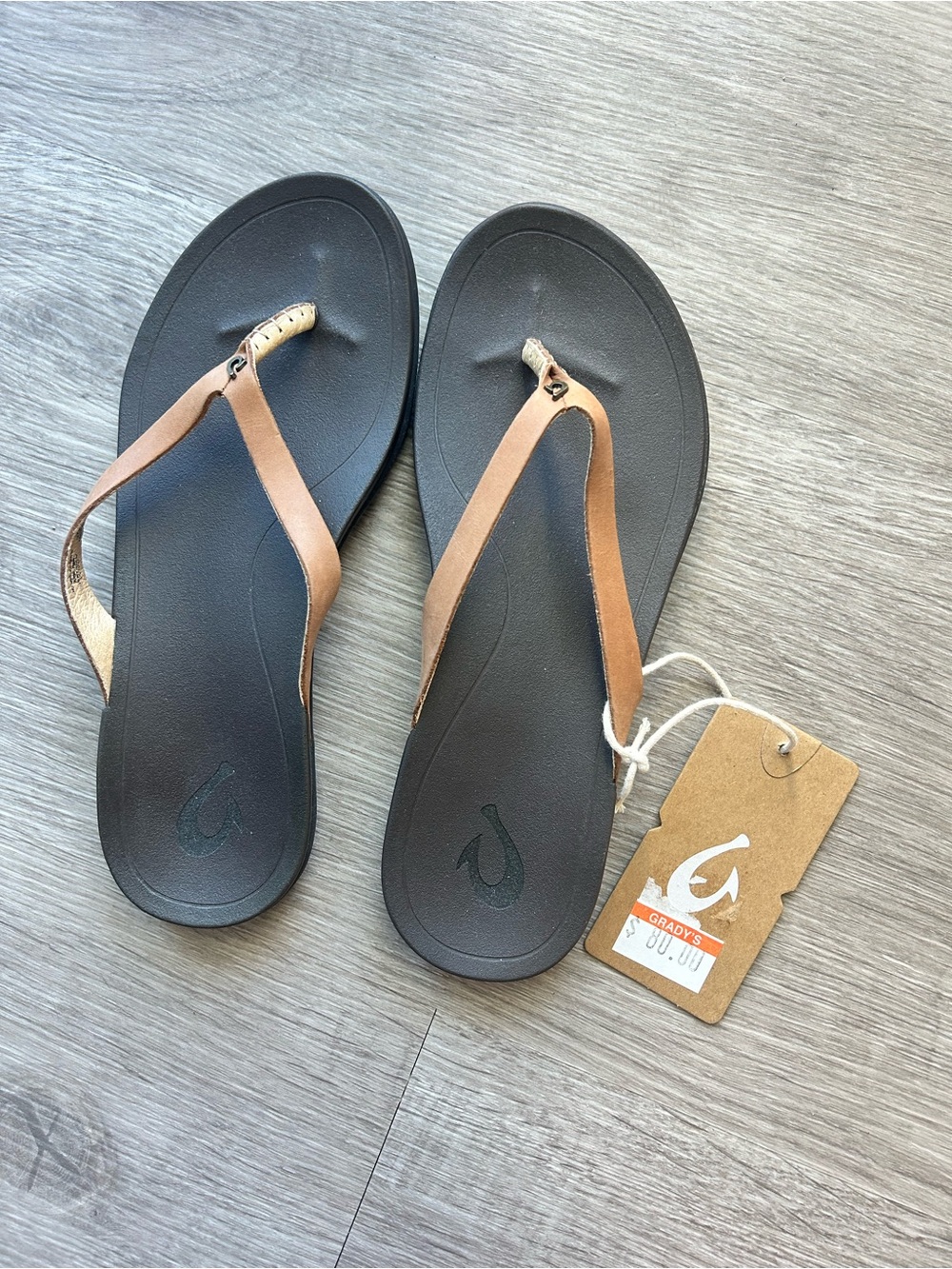 OluKai Women's Tan Strap Flip Flops with Black Footbed